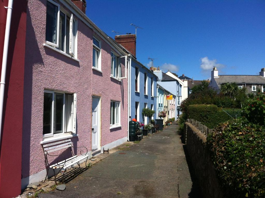 a row of colorful houses on a street at Tremanhire Cottage in Solva