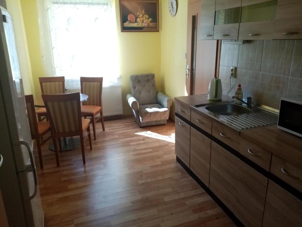 a kitchen with a sink and a table and chairs at Domek in Reľov