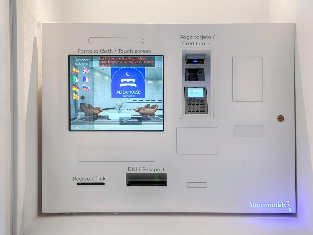 a machine with a screen on a wall at Hostal Altea House in Altea