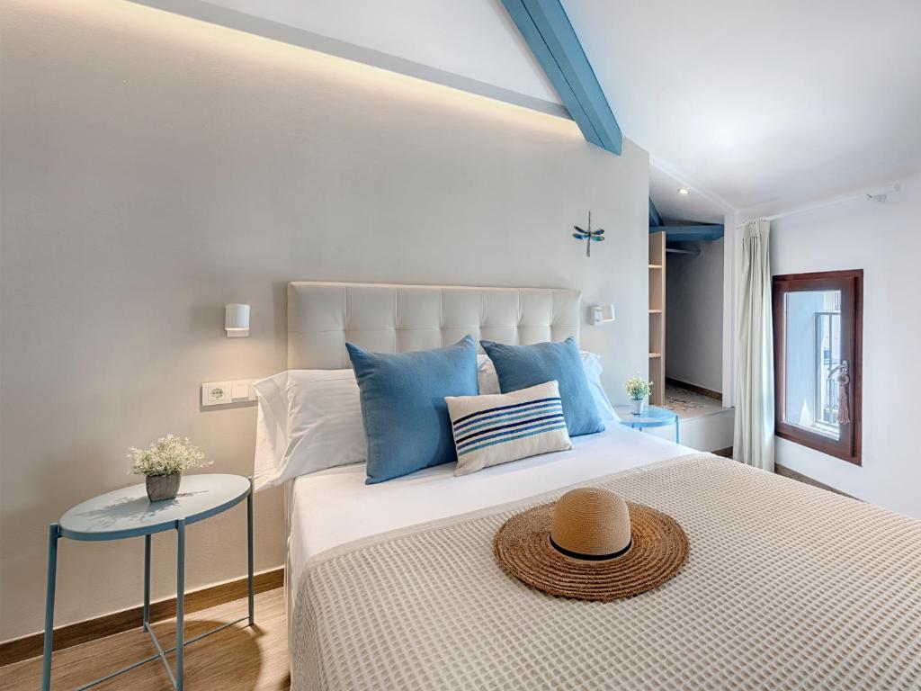 a bedroom with a large bed with a hat on it at Hostal Altea House in Altea