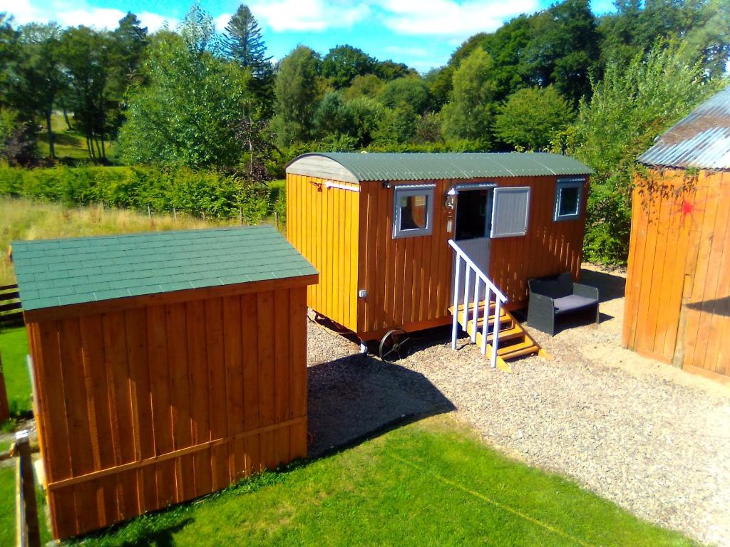 a couple of tiny homes sitting in a yard at Waterloo Farm Shepherds Hut Glamping in Perth