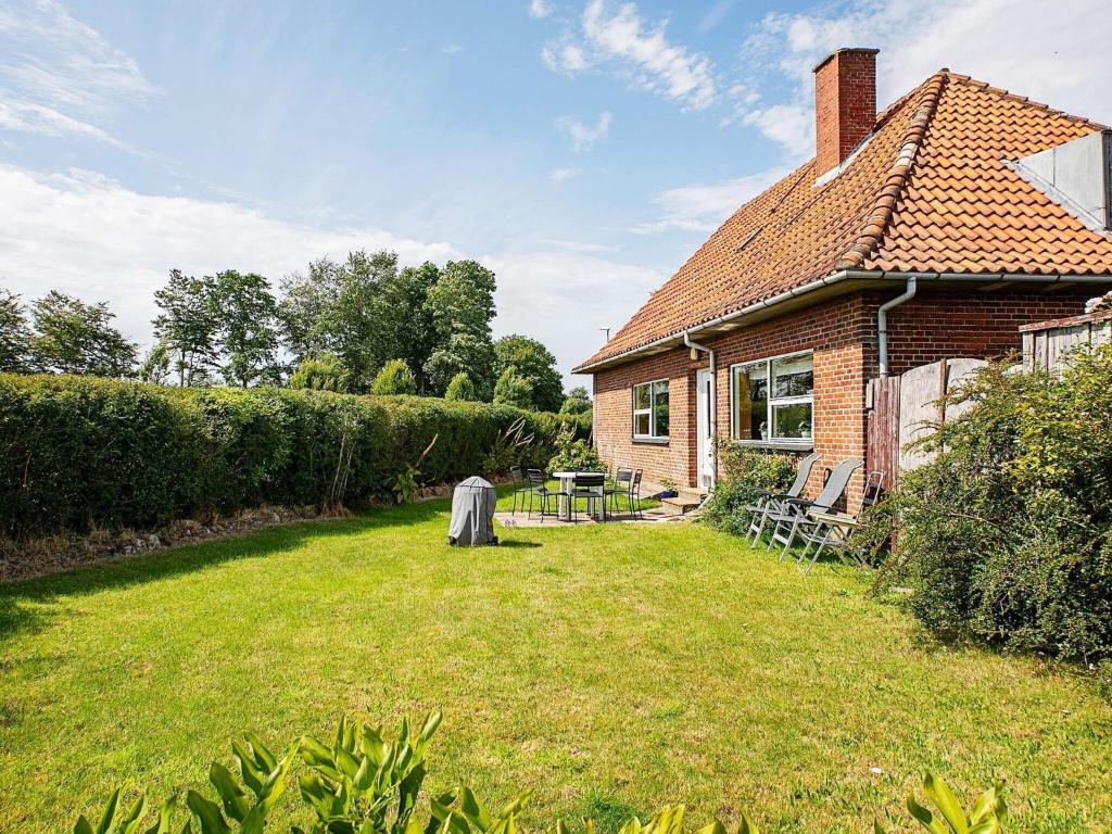a house with a grass yard next to a building at Holiday home Varde II in Varde