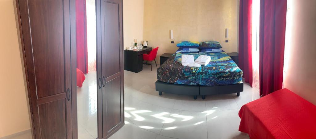 Posteľ alebo postele v izbe v ubytovaní National Gallery Taormina B&B