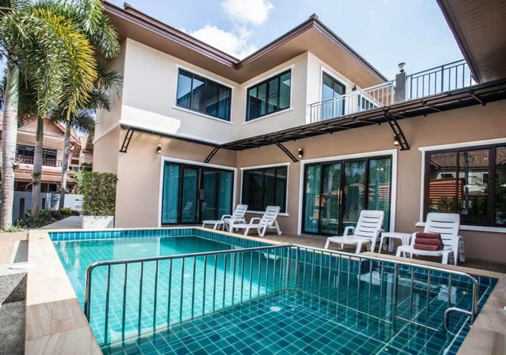 a villa with a swimming pool and a house at Poonsiri Private Pool Villa Aonang in Ao Nang Beach