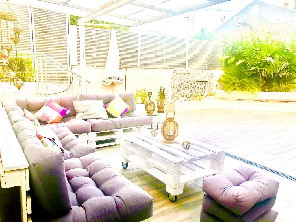 a living room with purple couches and a coffee table at 4 bedrooms house with enclosed garden and wifi at Rivas Vaciamadrid in Rivas-Vaciamadrid