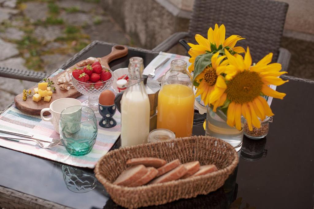 a table with food and drinks and a basket of food at Tmbin's barn - nature, horses, family in Sežana