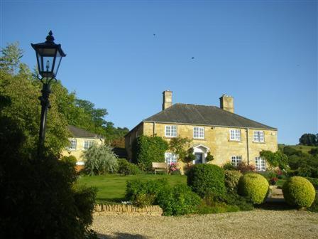 a large yellow house with a street light in front of it at The Apartment at Hillside Lodge in Broadway