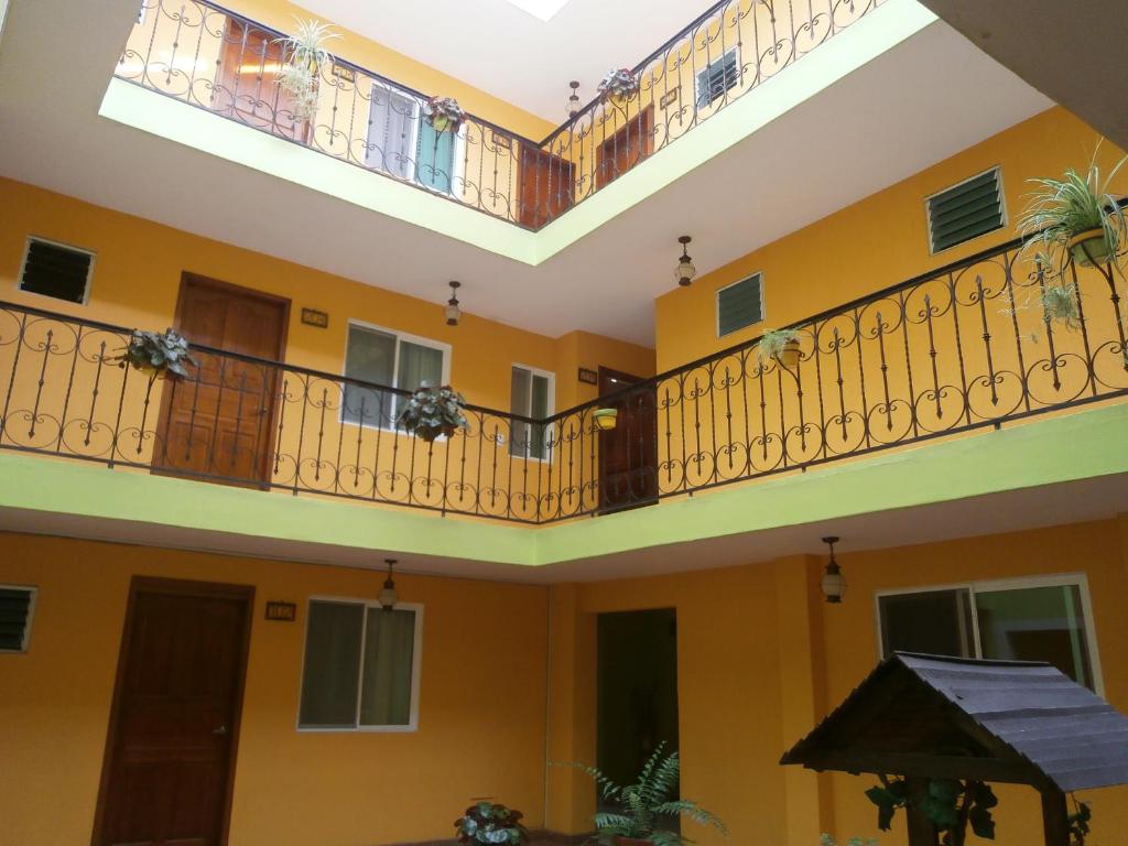 a room with yellow walls and balconies at Hotel Anber in Dolores Hidalgo