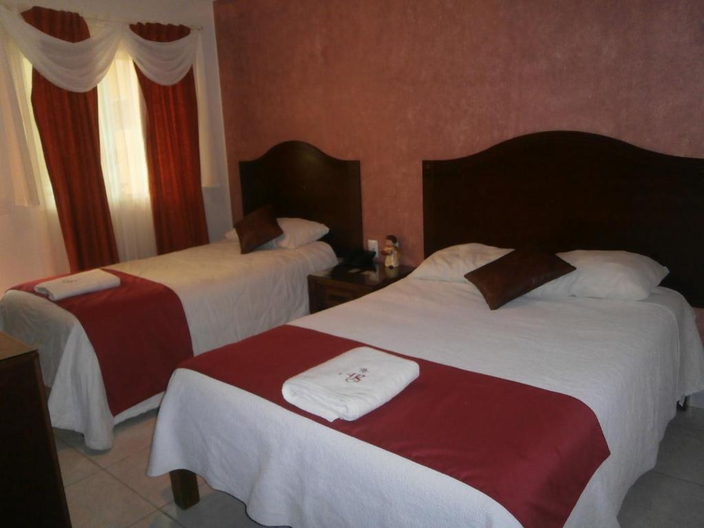 Postel nebo postele na pokoji v ubytování Hotel Anber