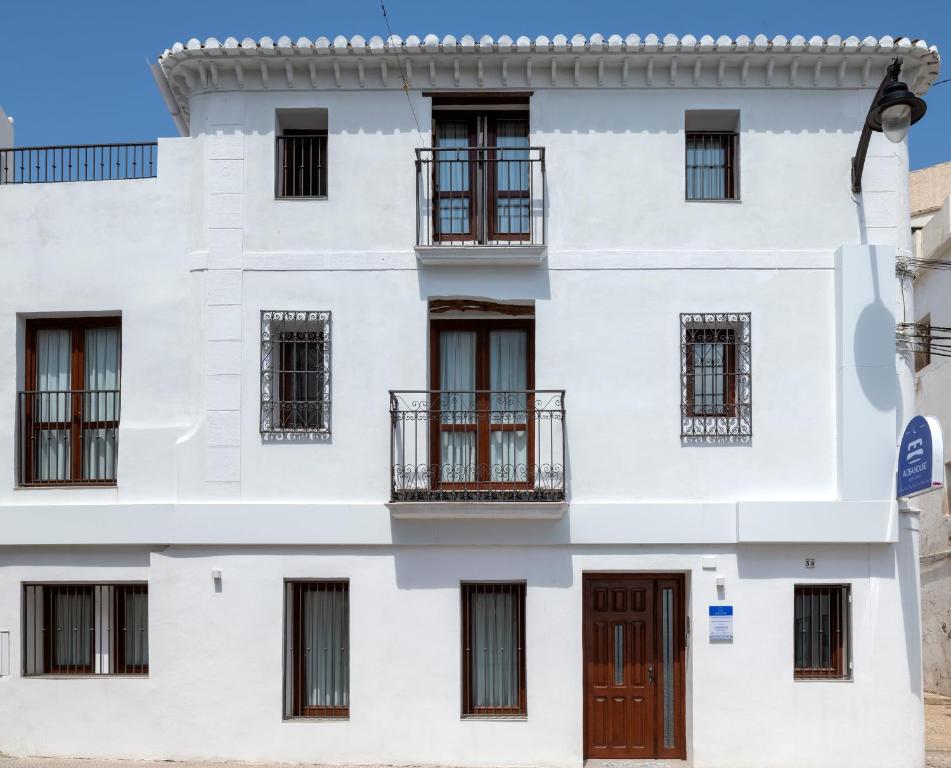 a white building with windows and doors at Hostal Altea House in Altea