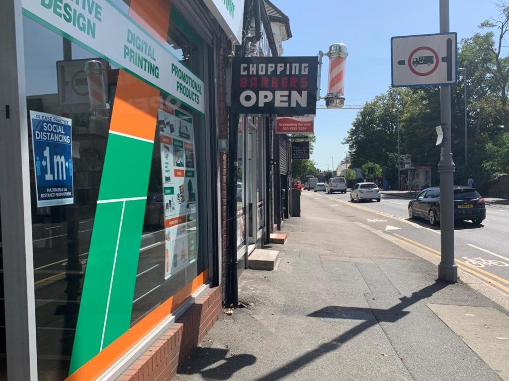 a street with signs on the side of a building at 03 Bedroom Apartment-Self Check in in London
