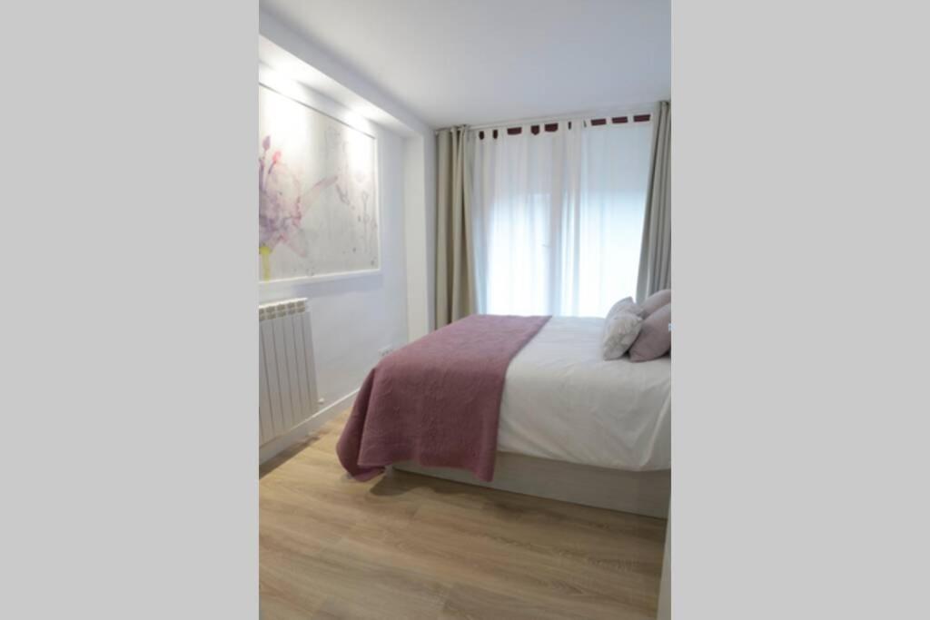 Postel nebo postele na pokoji v ubytování VUT La Casa de las Flores