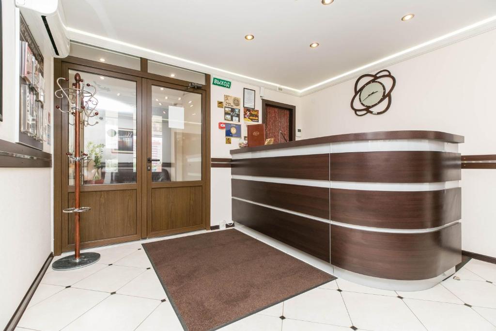 a lobby with a wooden front desk in a building at Mini-hotel Progress in Kolpino