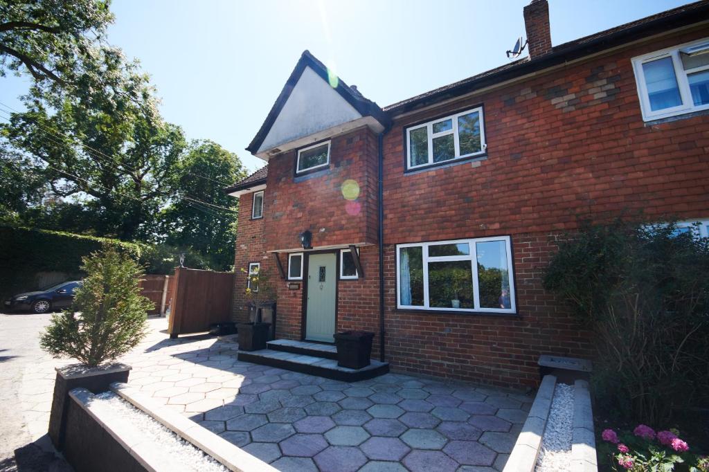 a red brick house with a white door at No.3 Buckland Cottages in Lymington