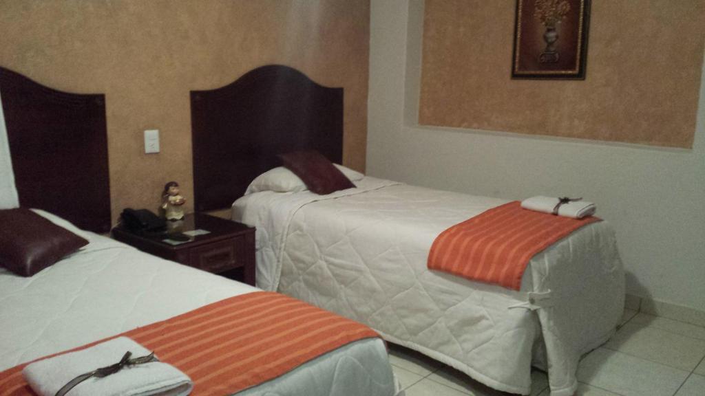 Postel nebo postele na pokoji v ubytování Hotel Anber