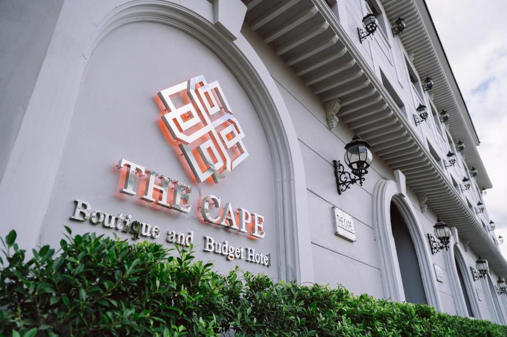 a sign on the side of a building at The Cape Hotel in Udon Thani
