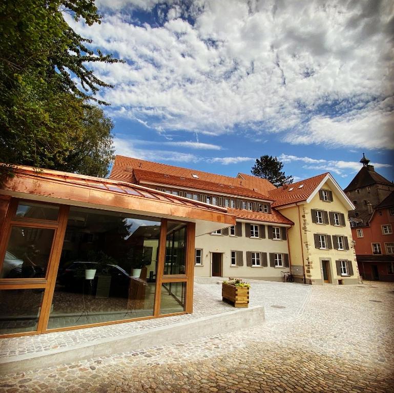 a building with glass doors in a courtyard at Haus am Schlossberg in Laufenburg