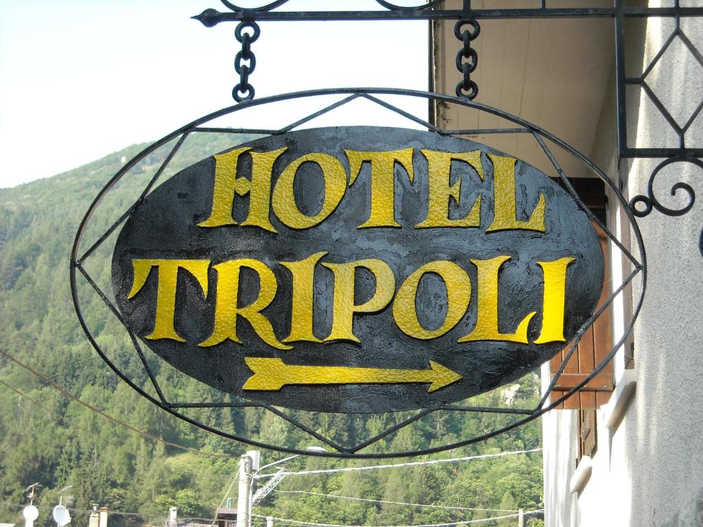 a sign for a hotelractor hanging on the side of a building at Hotel Tripoli La Margherita in Limone Piemonte