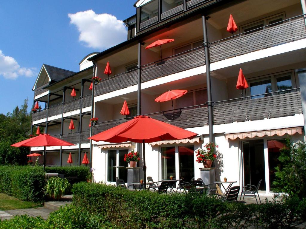a row of red umbrellas sitting on top of a building at Haus Katharina Hotel garni in Bad Steben
