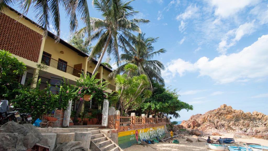 a house on the beach with palm trees at Haven Vietnam in Quy Nhon