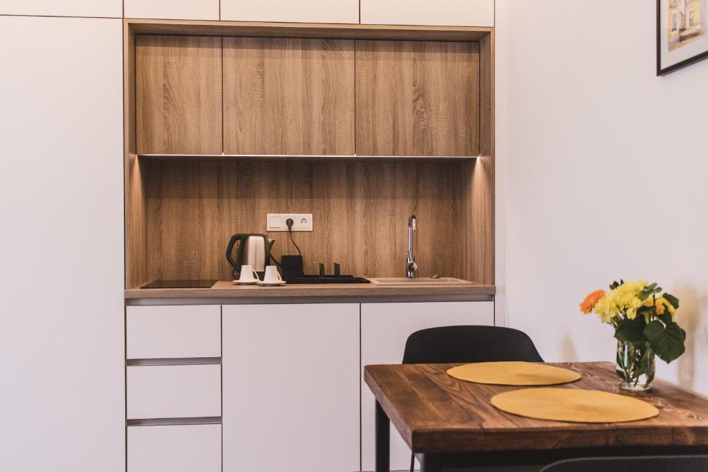 a kitchen with a wooden counter and a table at Mathias Rex in Szentendre