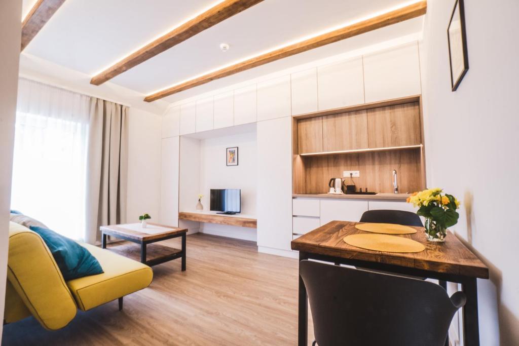 a kitchen and living room with a table and chairs at Mathias Rex in Szentendre