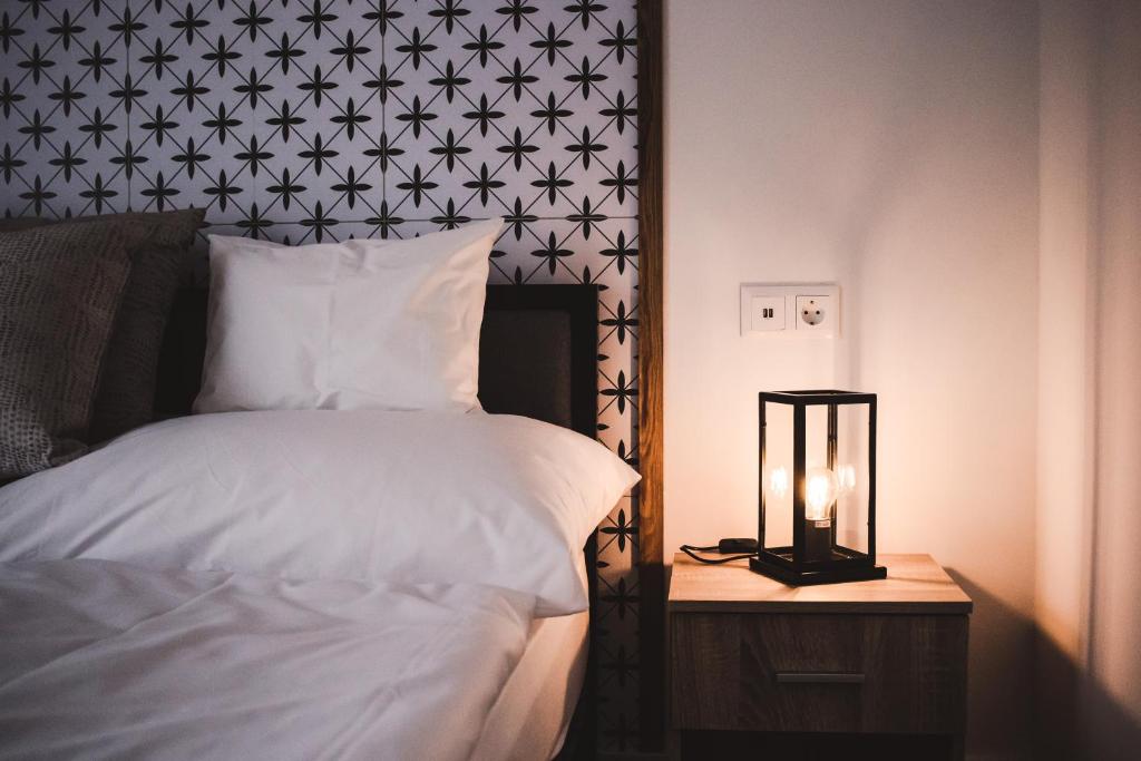 a bedroom with a bed and a night stand with a lamp at Mathias Rex in Szentendre