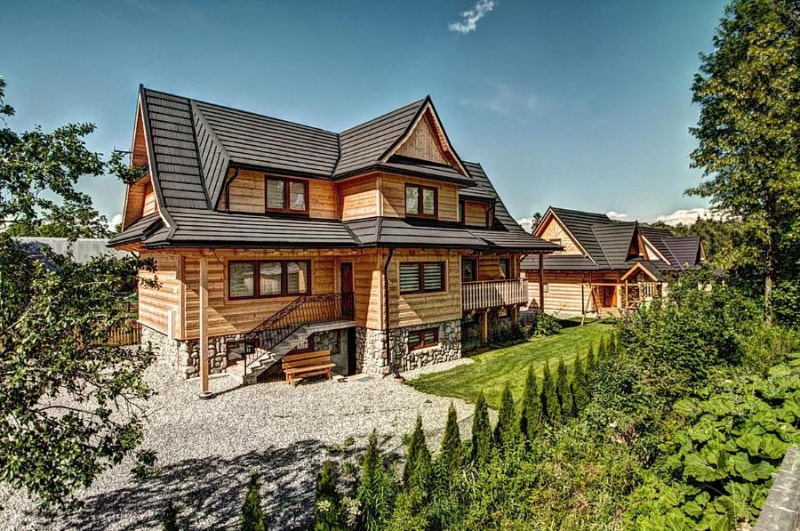a large wooden house on top of a hill at Osada HANKA Luxury in Witów