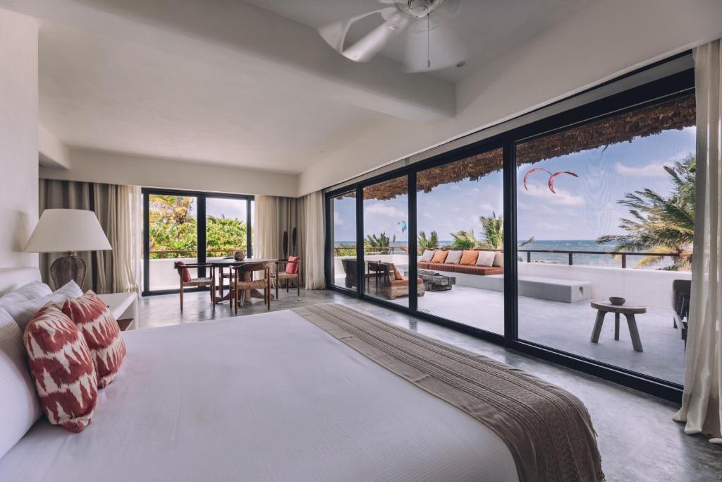 a hotel room with a view of the ocean at Chiringuito Tulum in Tulum