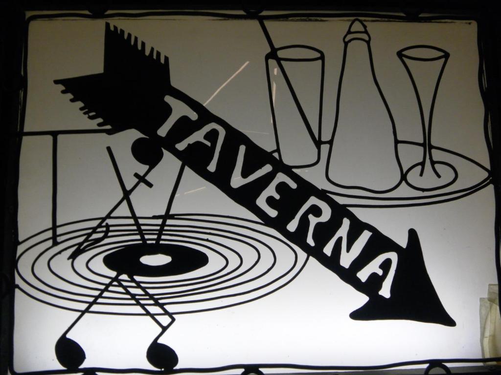 a sign with a music instrument on a wall at Hotel Tripoli La Margherita in Limone Piemonte