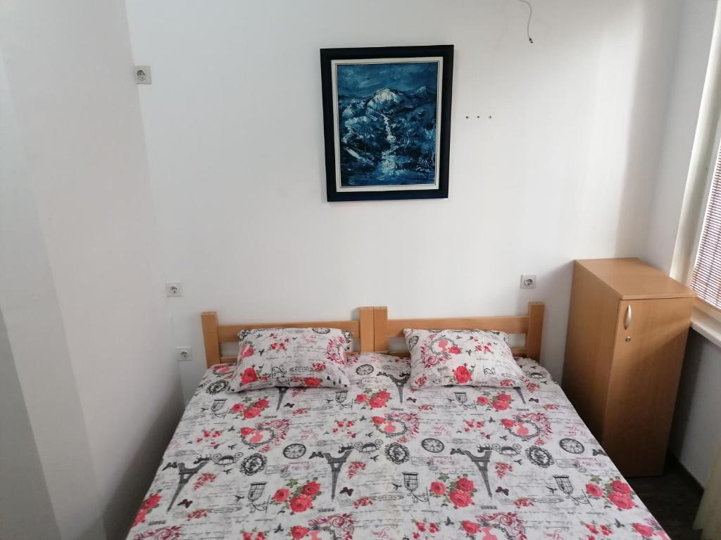 a bedroom with a bed with a quilt and pillows at Exit Labirint Centar in Novi Sad