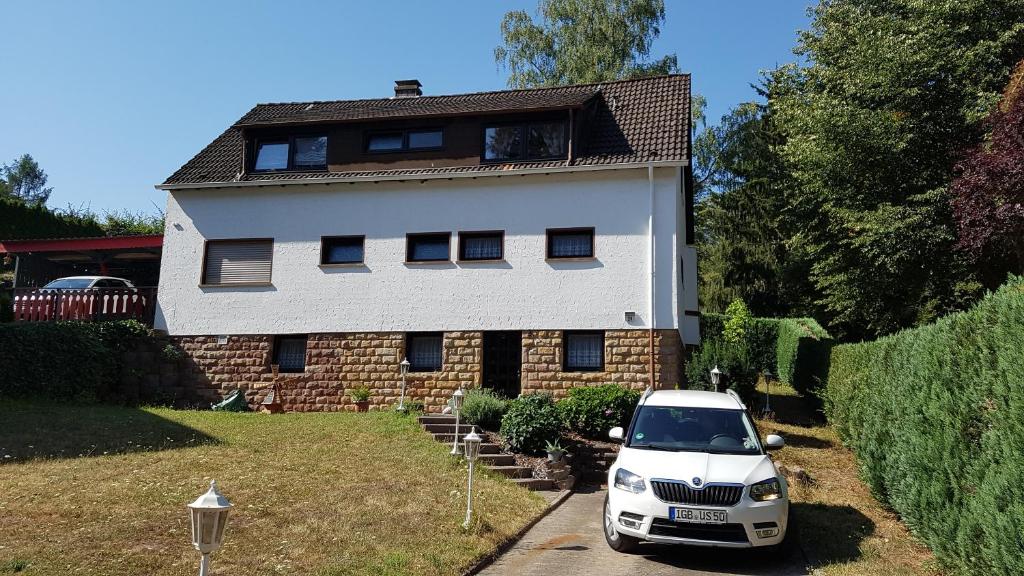 a white car parked in front of a house at Rentrisch am Waldrand in Sankt Ingbert