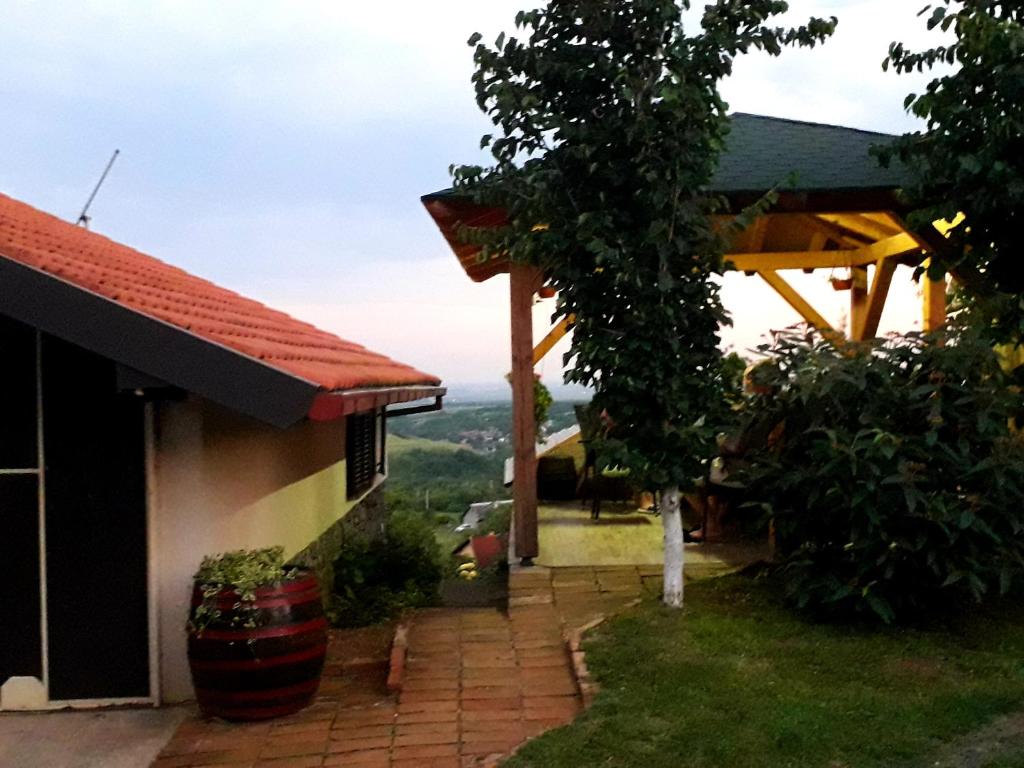 a view of a house with a patio and a tree at Apartment Noletov vidikovac in Vrdnik
