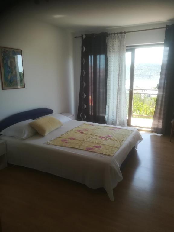 Postel nebo postele na pokoji v ubytování Apartmani Huljev