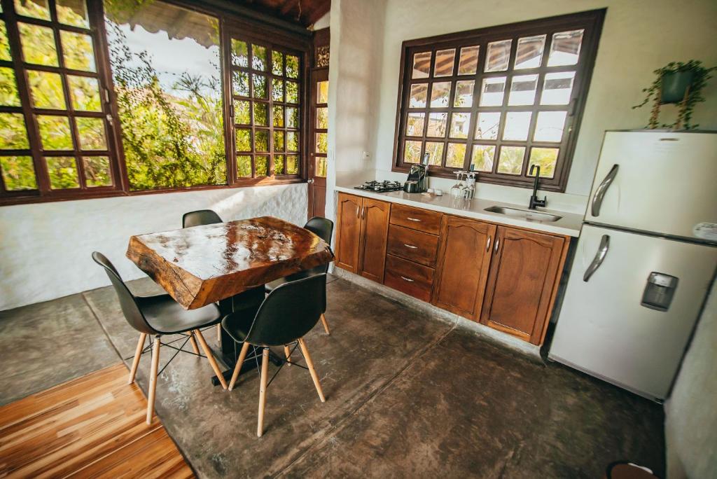a kitchen with a table and chairs and a refrigerator at Bio Habitat Hotel in Armenia
