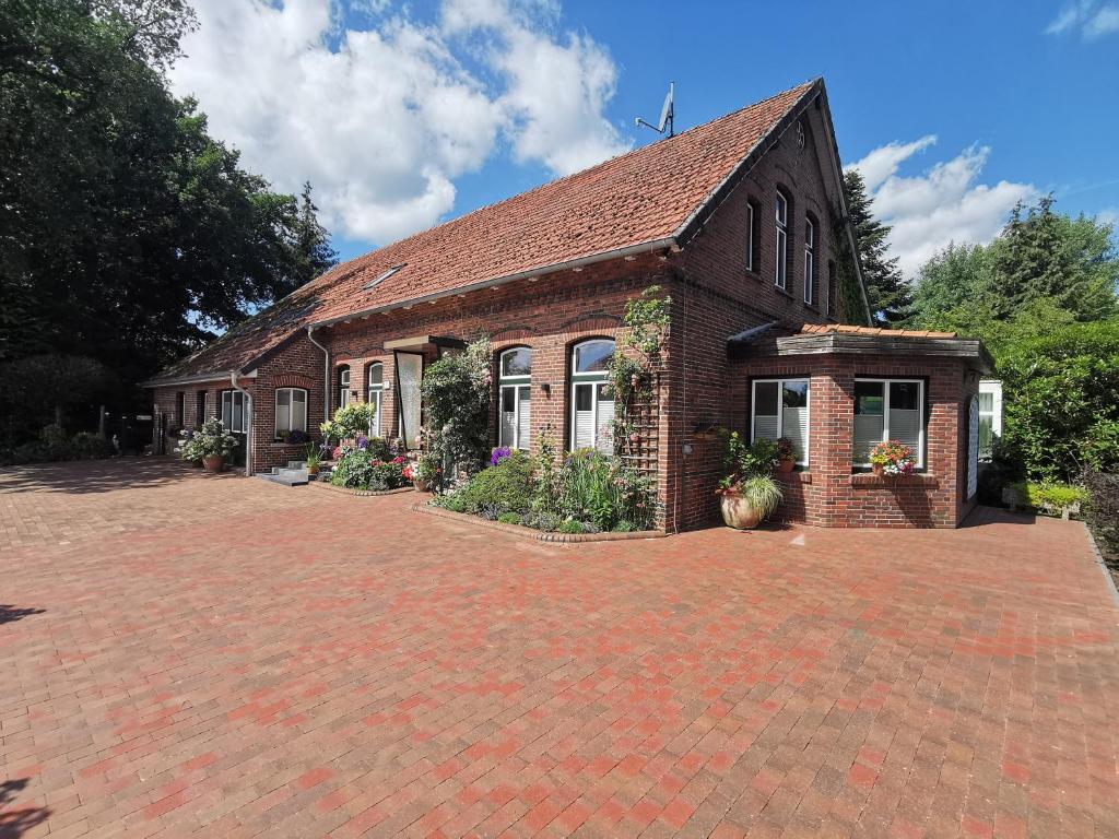 a brick building with a brick driveway in front of it at HausAltenkamp in Bad Zwischenahn