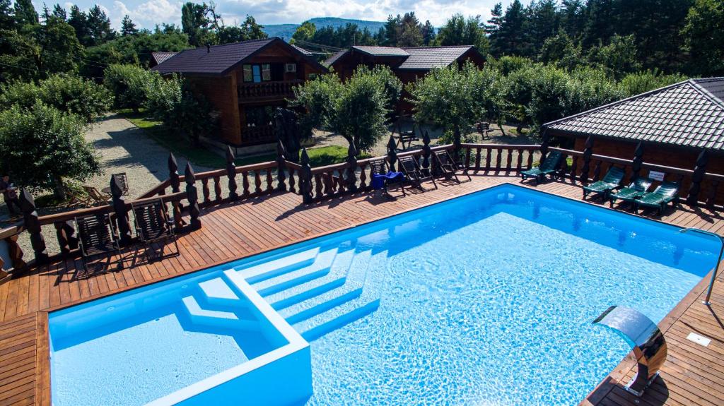 an overhead view of a swimming pool on a wooden deck at Barskaya Usadba in Kamennomostskiy