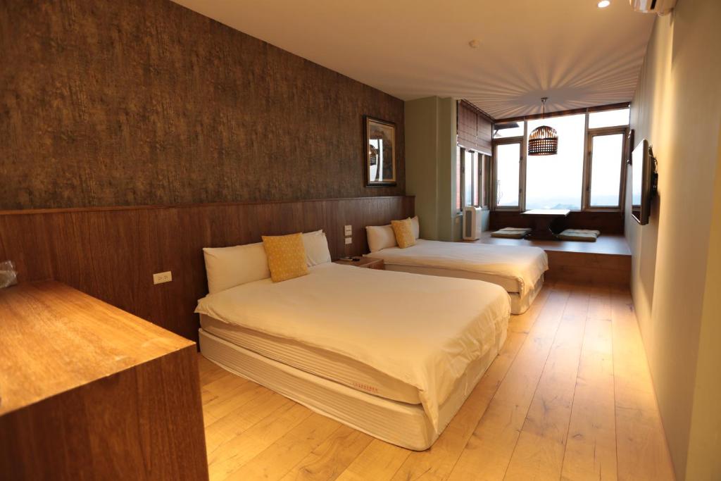 Postel nebo postele na pokoji v ubytování Jiufen HappyLand B&B