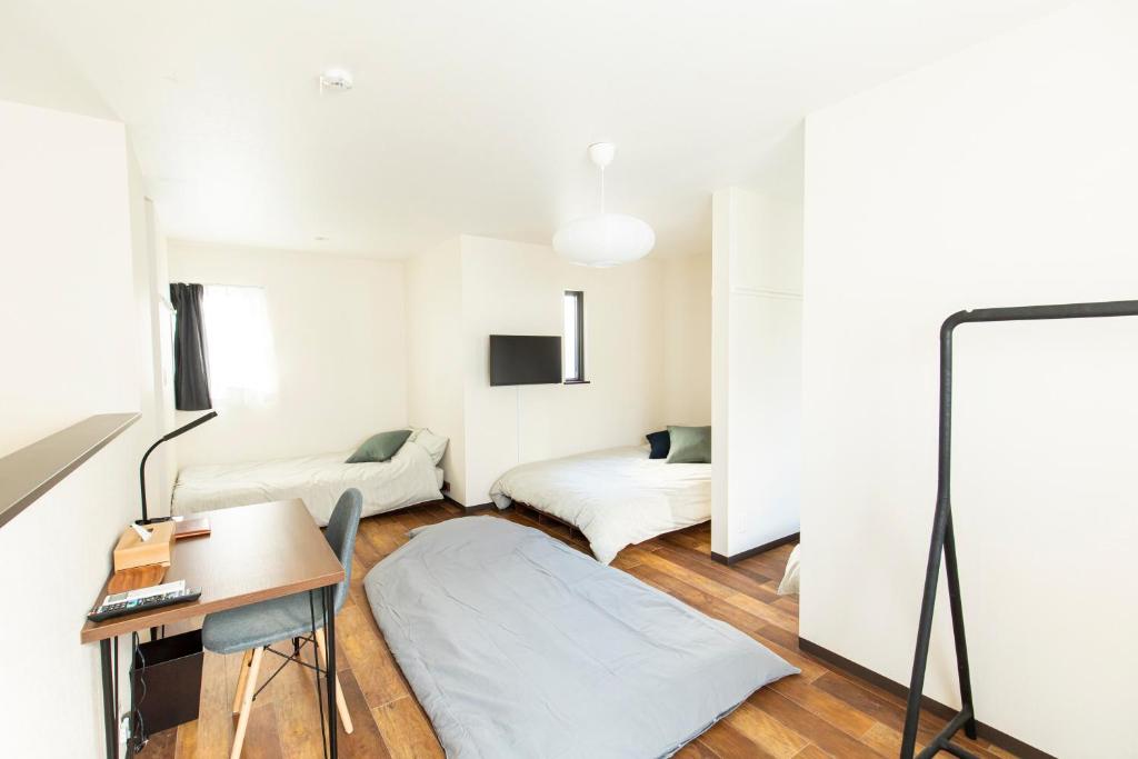 Postel nebo postele na pokoji v ubytování YUFU-Inn プライベートな露天風呂付き-由布院駅徒歩2分-最大8名宿泊可能