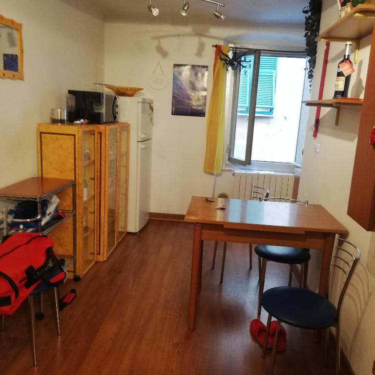 a kitchen with a table and chairs in a room at nirvana in Genoa