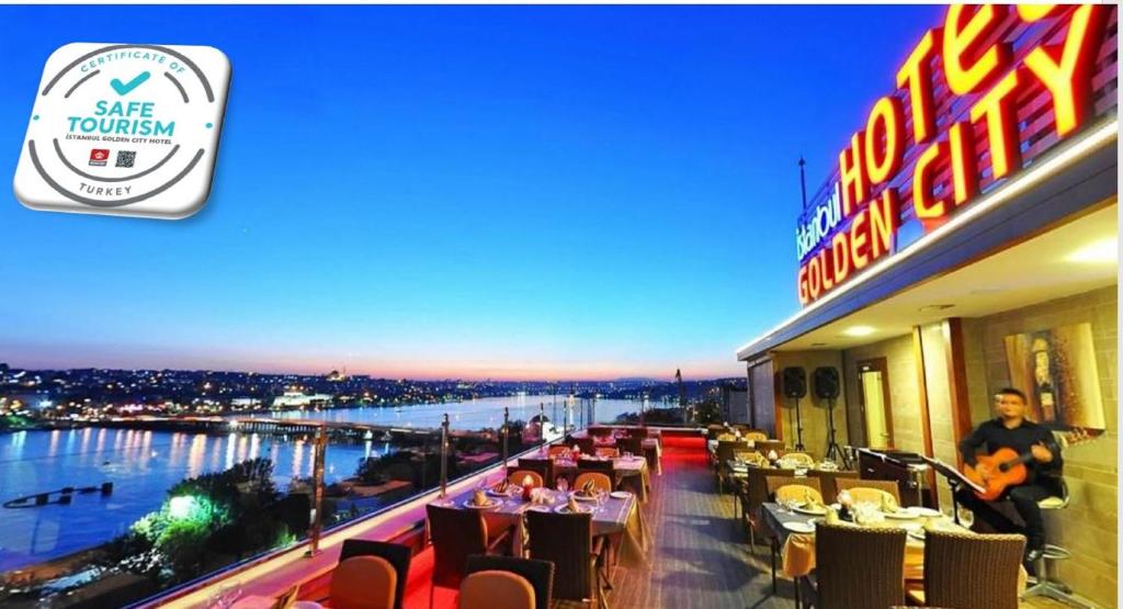 a restaurant with a view of a river and people sitting at tables at Istanbul Golden City Hotel in Istanbul