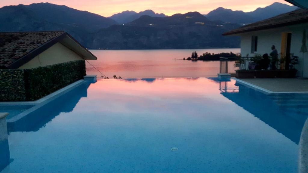 a swimming pool with a view of a body of water at Hotel Garden in Malcesine