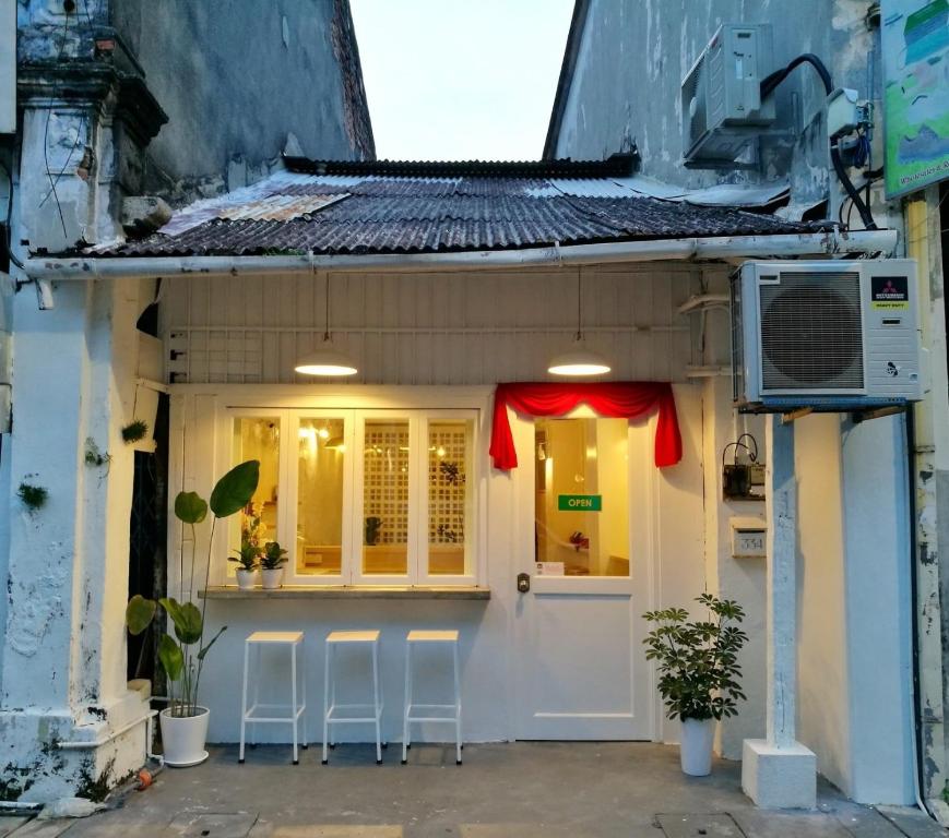 a small house with stools outside of it at Stay SongSong Beach Street in George Town