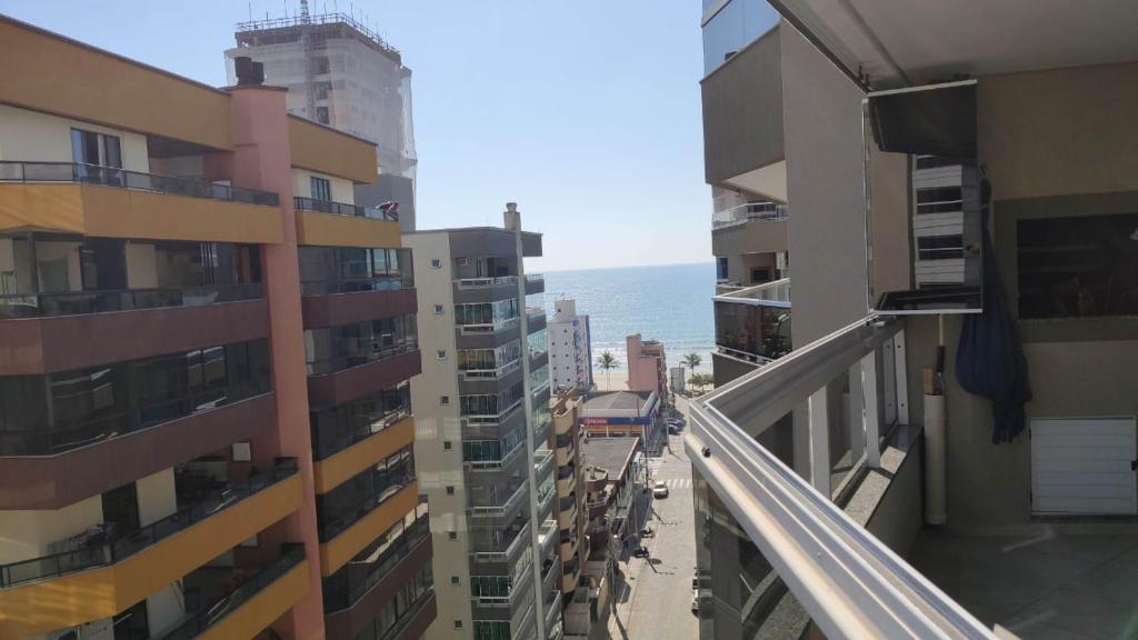 a view of the ocean from the balcony of a building at Apartamento confortável em Meia Praia - 200 metros da praia in Itapema