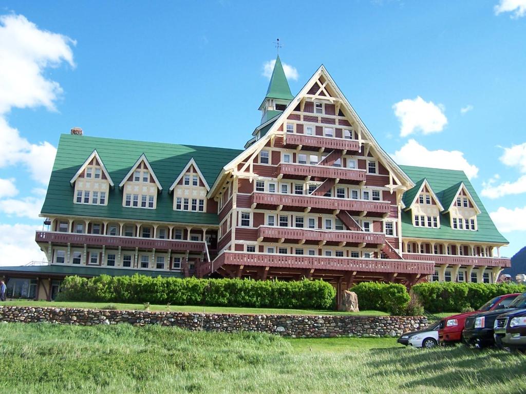 a large brick building with a clock on the side of it at Prince of Wales Hotel in Waterton Park