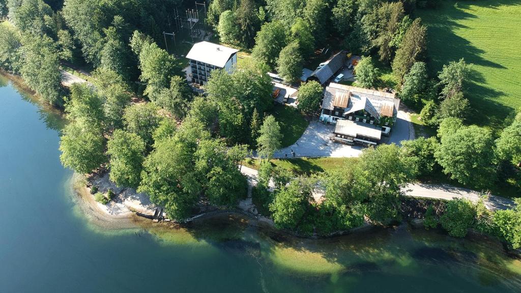 an aerial view of a house on an island in the water at Hostel pod Voglom in Bohinj
