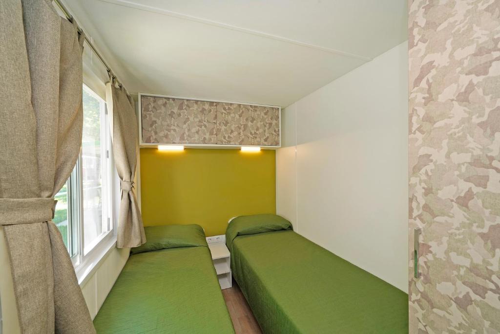Postel nebo postele na pokoji v ubytování San Francesco Camping Village
