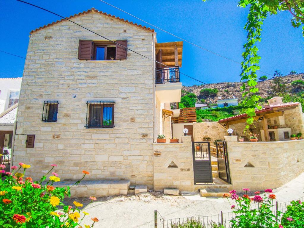 a large stone house in front of a mountain at Christine Countryside House - Fully renovated with all modern comforts in Rodhopós