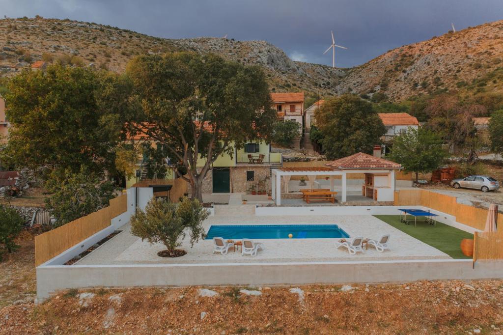 a villa with a swimming pool and a house at Villa Vuki in Šibenik