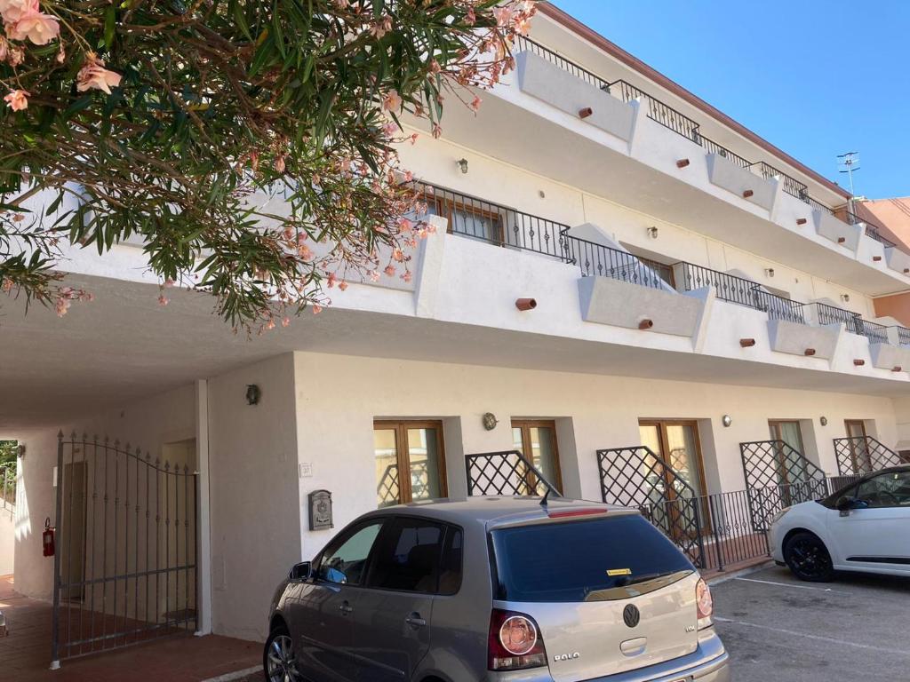 a car parked in a parking lot in front of a building at Le Gemme di Mirto in Palau